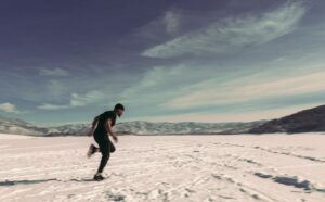 man running in snow in winter